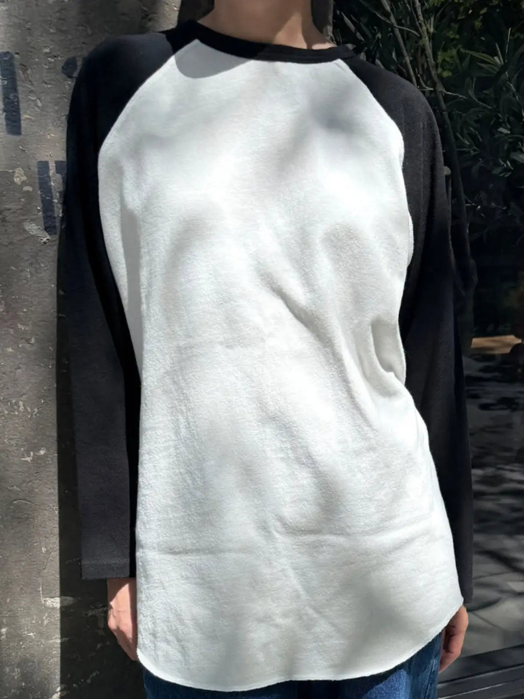 A front view highlights the relaxed fit, classic crew neck, and curved hem of the Le Bon Shoppe Heavy Cotton Raglan Tee in White/Black | Twentyseven Toronto