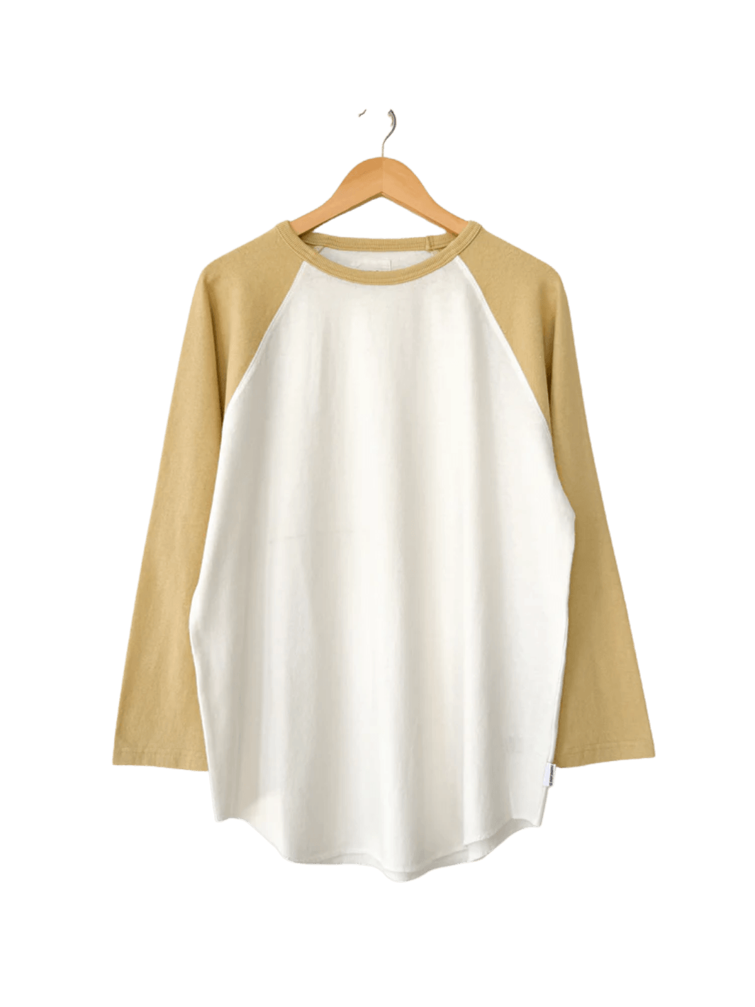 The two-toned white and yellow Le Bon Shoppe Heavy Cotton Raglan Tee in White/Butter hangs straight from a wooden hanger | Twentyseven Toronto