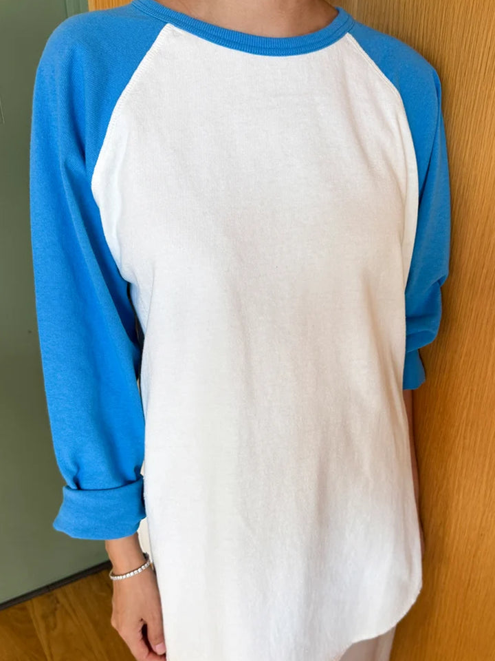 Model wearing the Le Bon Shoppe Heavy Cotton Raglan in white with blue long sleeves | Twentyseven Toronto