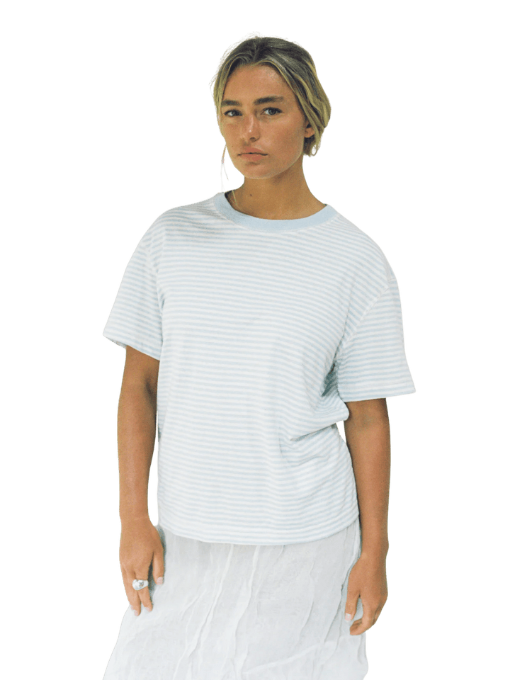 A model wearing the casual, short-sleeved Merge Goods Hemp Rover Tee in Daydream Stripes | Twentyseven Toronto