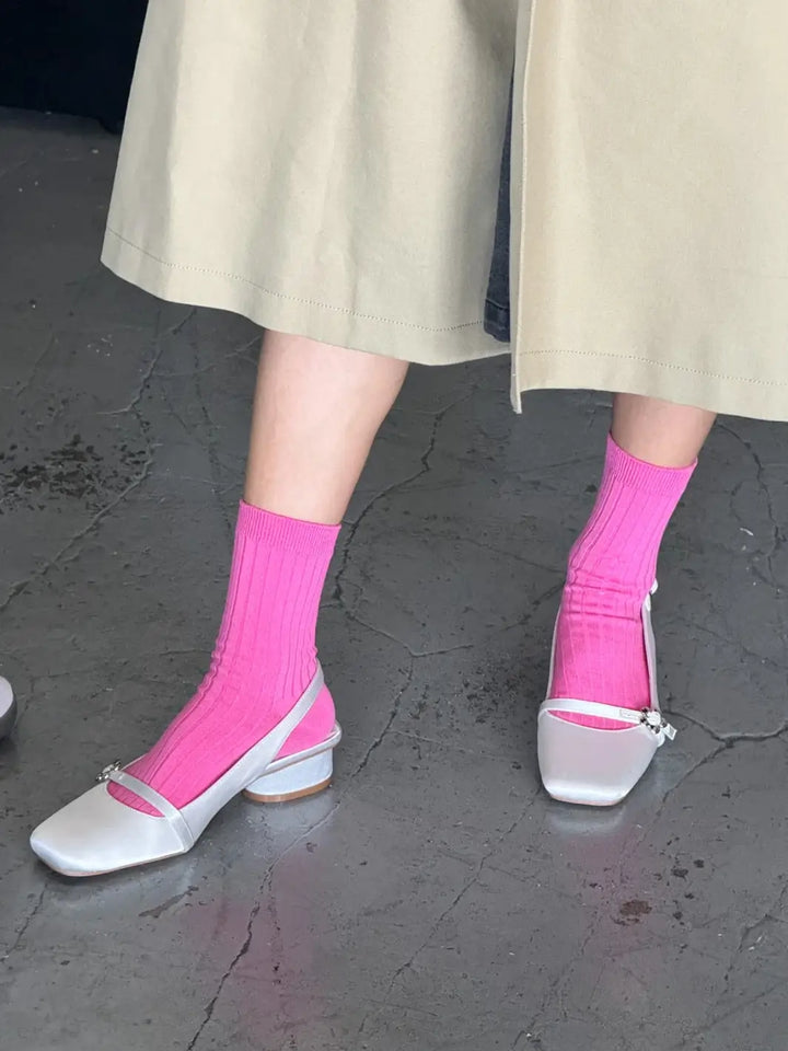 Person wearing Le Bon Shoppe Her Socks in Bright Pink and white shoes on a grey pavement | Twentyseven Toronto