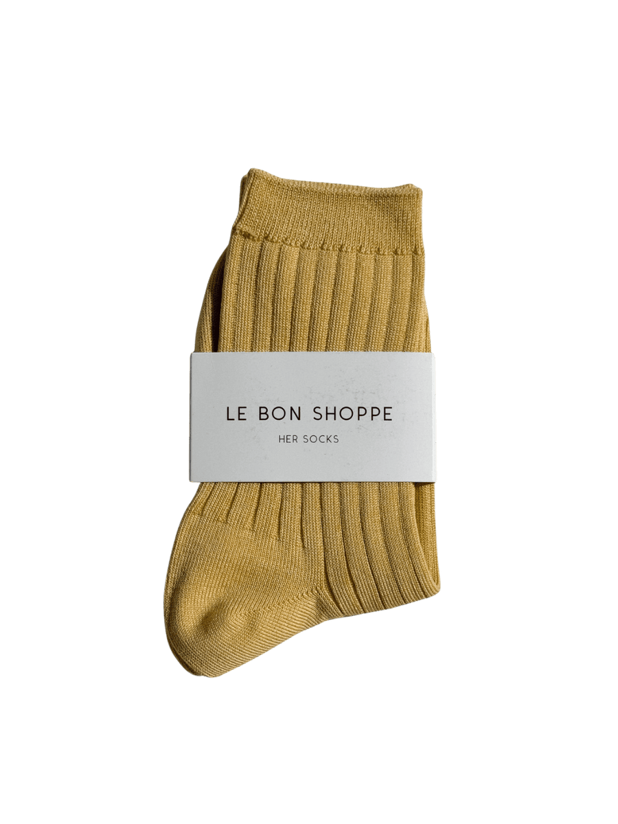 Mustard yellow Le Bon Shoppe Her Socks (MC Cotton) in Buttercup with a white label on a transparent background | Twentyseven Toronto