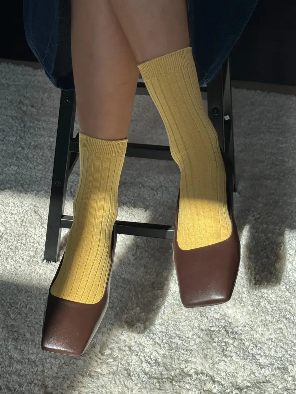 Person wearing mustard yellow Le Bon Shoppe Her Socks in Buttercup and brown flats on a white rug background | Twentyseven Toronto