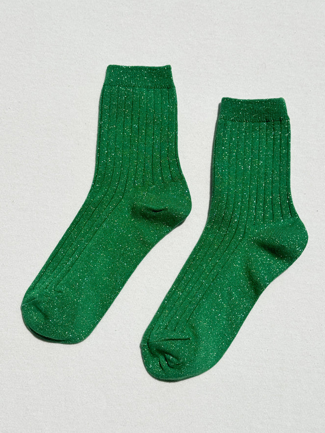 Pair of Le Bon Shoppe Her Socks Lurex in Emerald Glitter featuring a bright green ribbed knit and metallic shimmer | Twentyseven Toronto