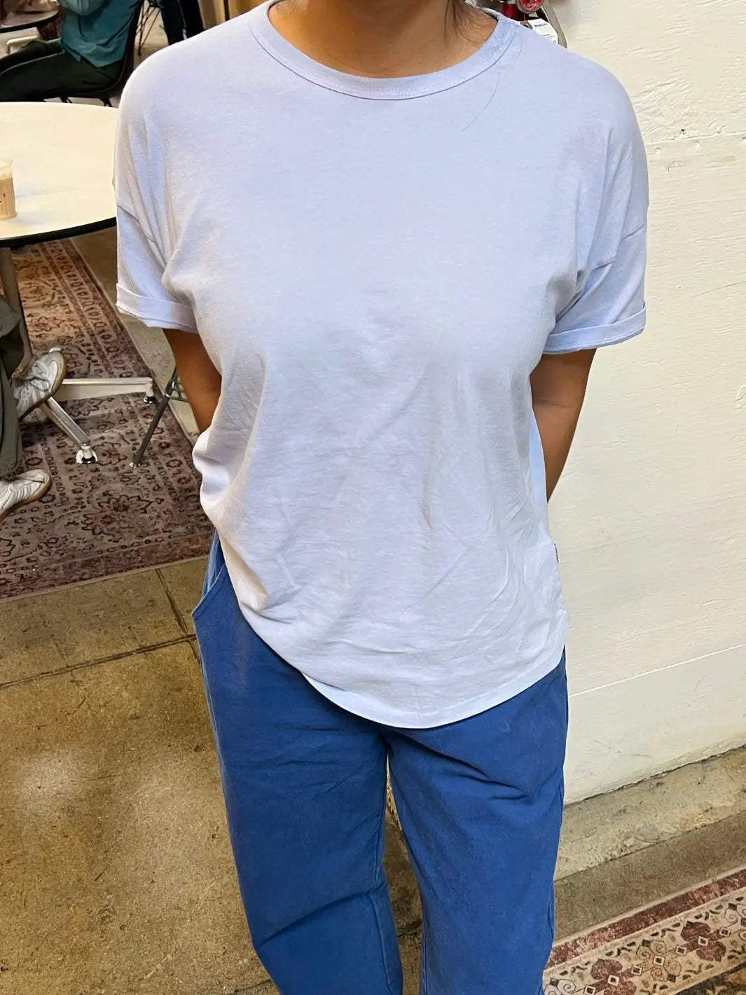 Person wearing a light blue Her Tee in 'Serenity' from Le Bon Shoppe and dark blue pants outdoors | Twentyseven Toronto