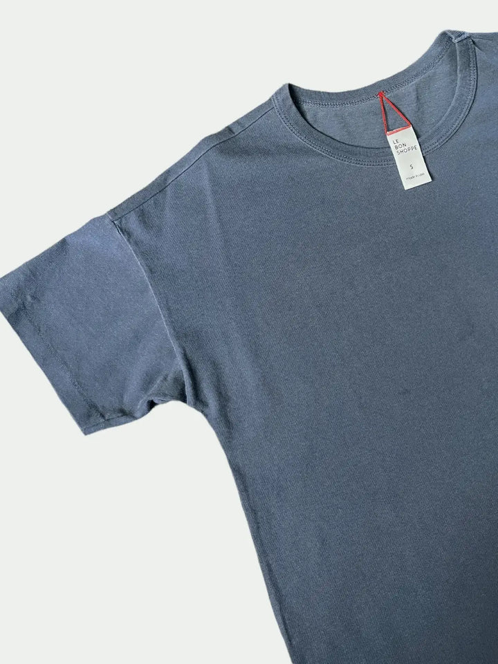 Blue Her Tee in 'Vintage Navy' from Le Bon Shoppe with a tag laid flat on a white background | Twentyseven Toronto