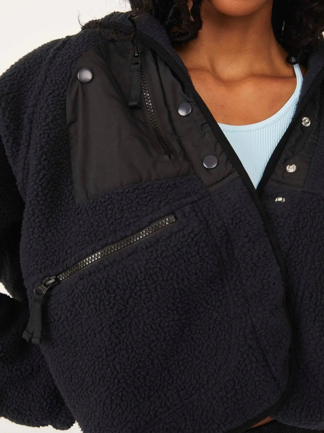 A detailed front close-up emphasizes the contrasting woven chest pocket panel and zippered lower pocket on the Free People Hit The Slopes Fleece Jacket - Black | Twentyseven Toronto