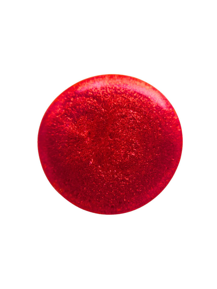 Circular color swatch on a plain white background illustrates the shimmery, metallic red hue of Death Valley Nails Hot Tamale Nail Polish | Twentyseven Toronto