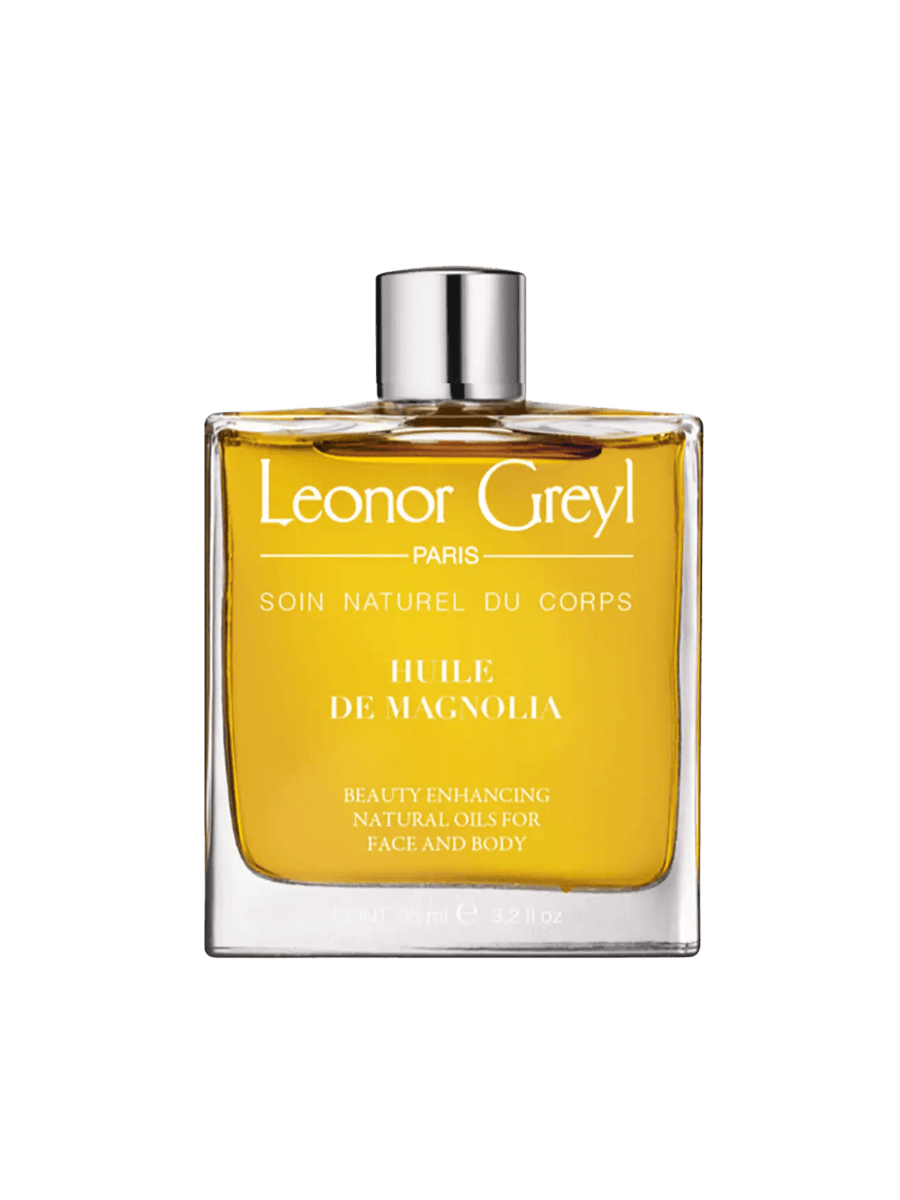 Glass bottle of gold liquid 'Huile de Magnolia' by Leonor Greyl on a transparent background | Twentyseven Toronto