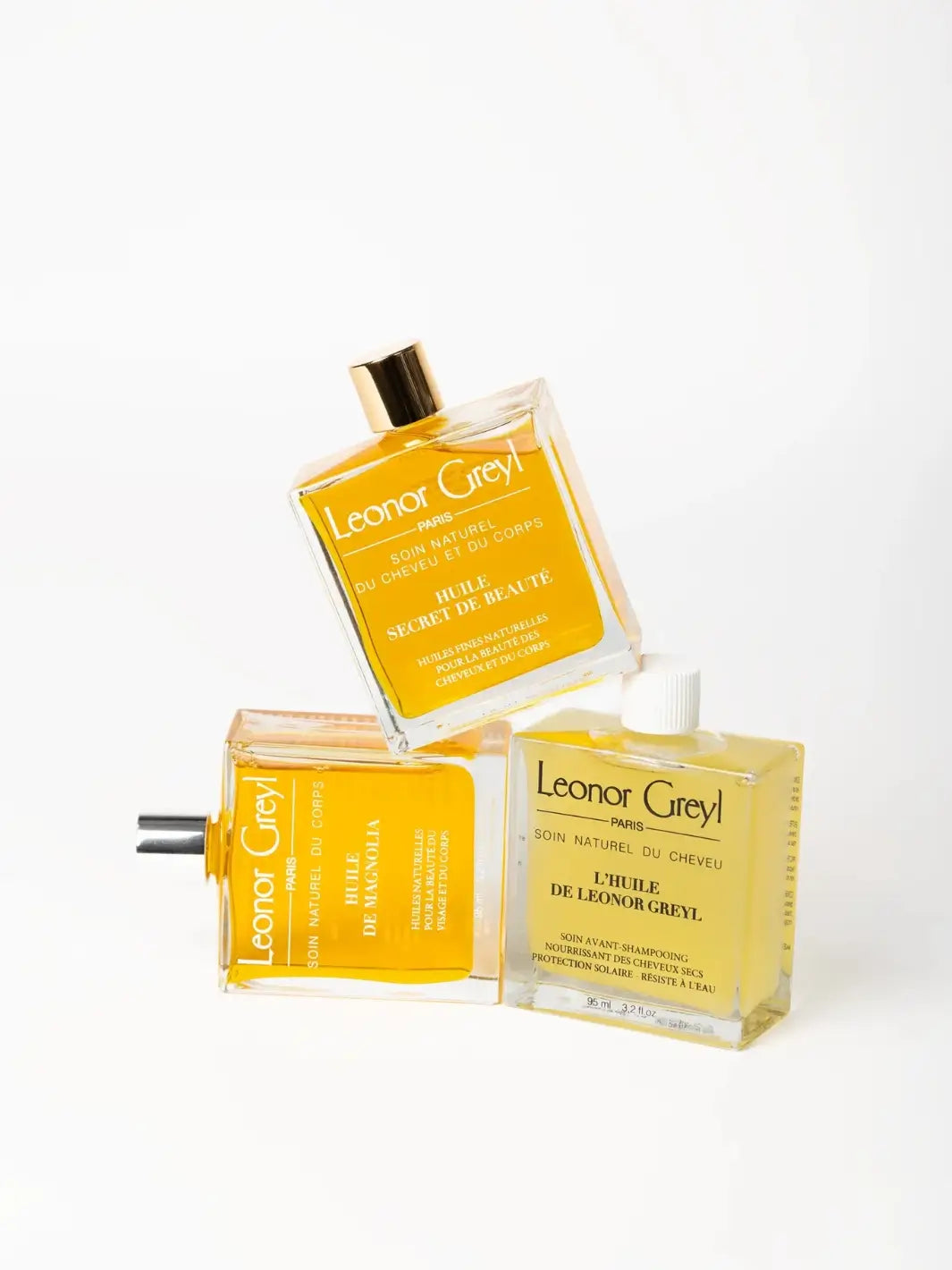 Three Leonor Greyl hair care products including 'Huile de Magnolia, 'Huile Secret de Beauté' and 'L’Huile de Leonor Greyl' on a white background | Twentyseven Toronto