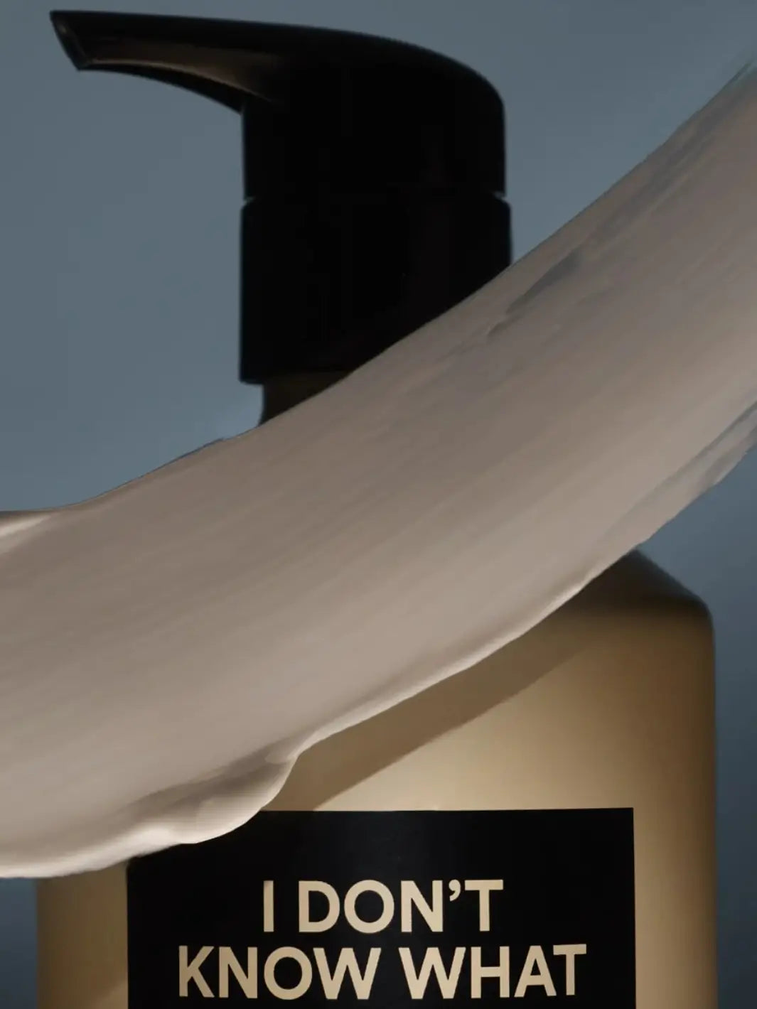 Close-up of a DS & Durga pump bottle and product texture swatch with label 'I DON'T KNOW WHAT' on a blue background | Twentyseven Toronto