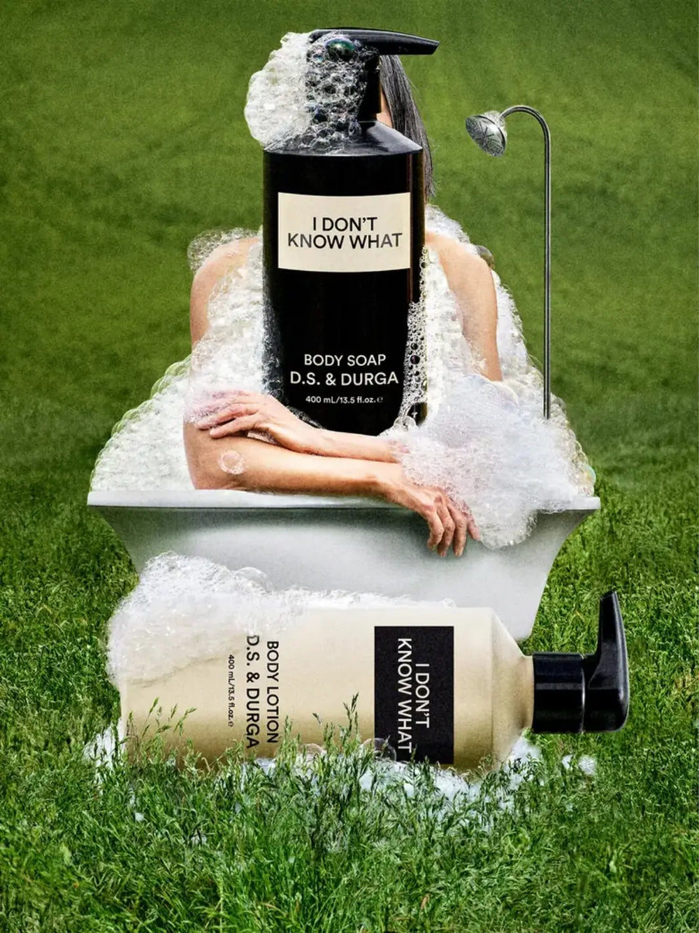 Person in a bathtub with 'I Don't Know What' body soap and shower gel from DS&Durga, surrounded by grass | Twentyseven Toronto
