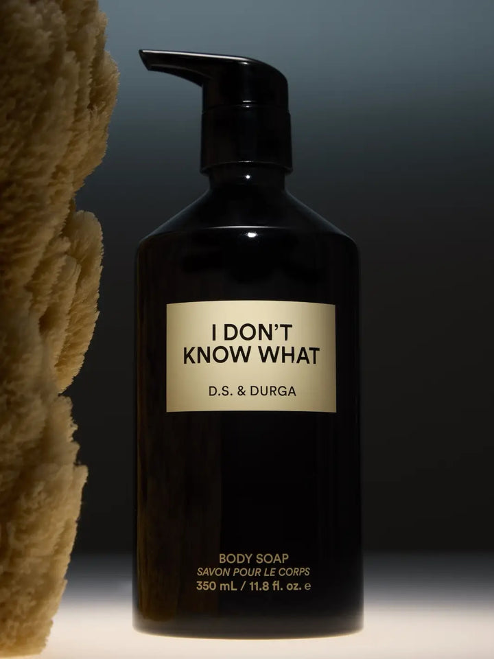 Black bottle of D.S. & Durga body soap  with a beige 'I Don't Know What' label on a dark background | Twentyseven Toronto