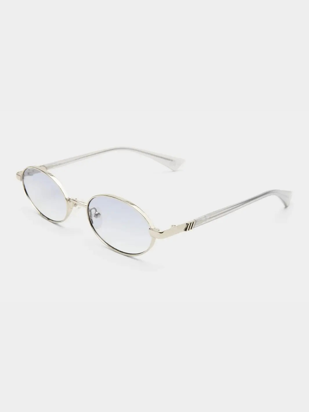 A three-quarter studio product shot of the Le Specs Icicle - Silver Smoke Grad sunglasses showcasing their slim silver metal frame, gradient lenses, and clear temple tips | Twentyseven Toronto