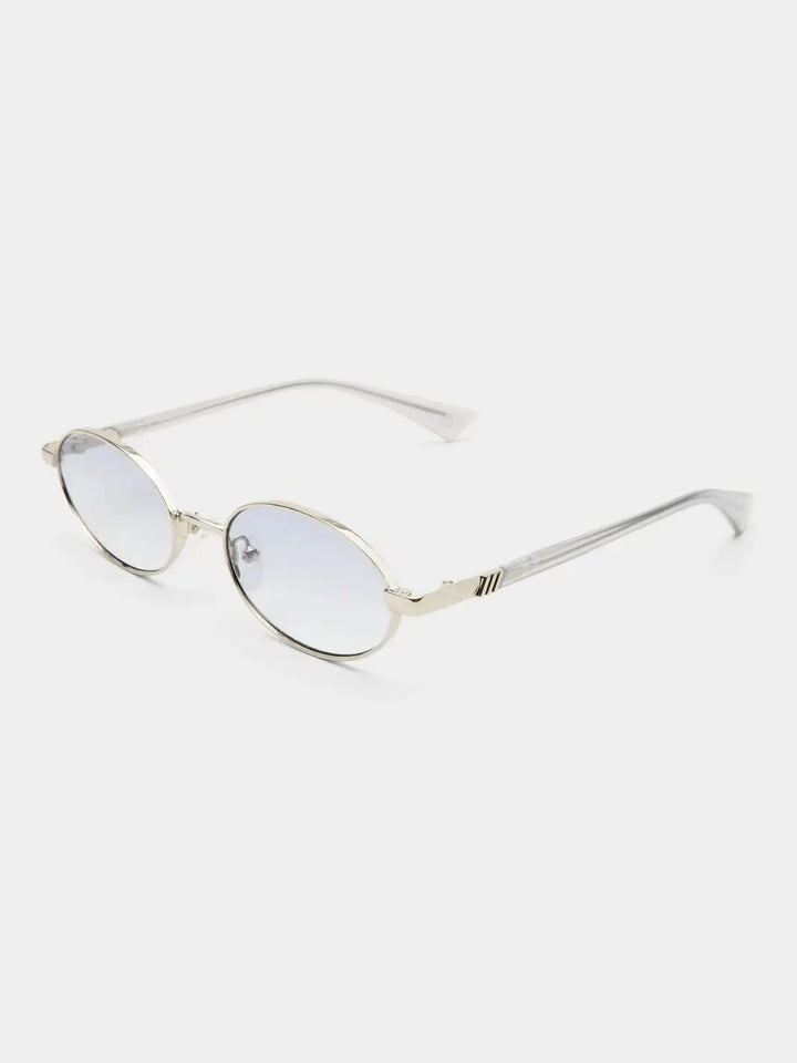 A three-quarter studio product shot of the Le Specs Icicle - Silver Smoke Grad sunglasses showcasing their slim silver metal frame, gradient lenses, and clear temple tips | Twentyseven Toronto