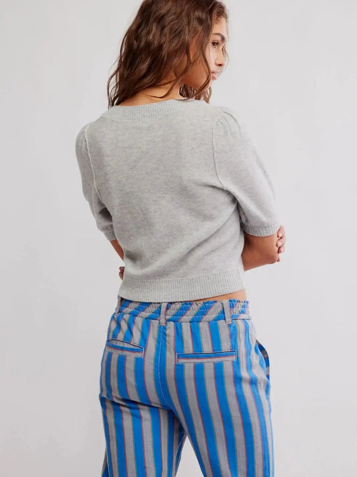 A view from the back highlights the structured crew neckline and ribbed waistband of the form-fitting Free People Isla Solid Cardi - Mineral Grey | Twentyseven Toronto