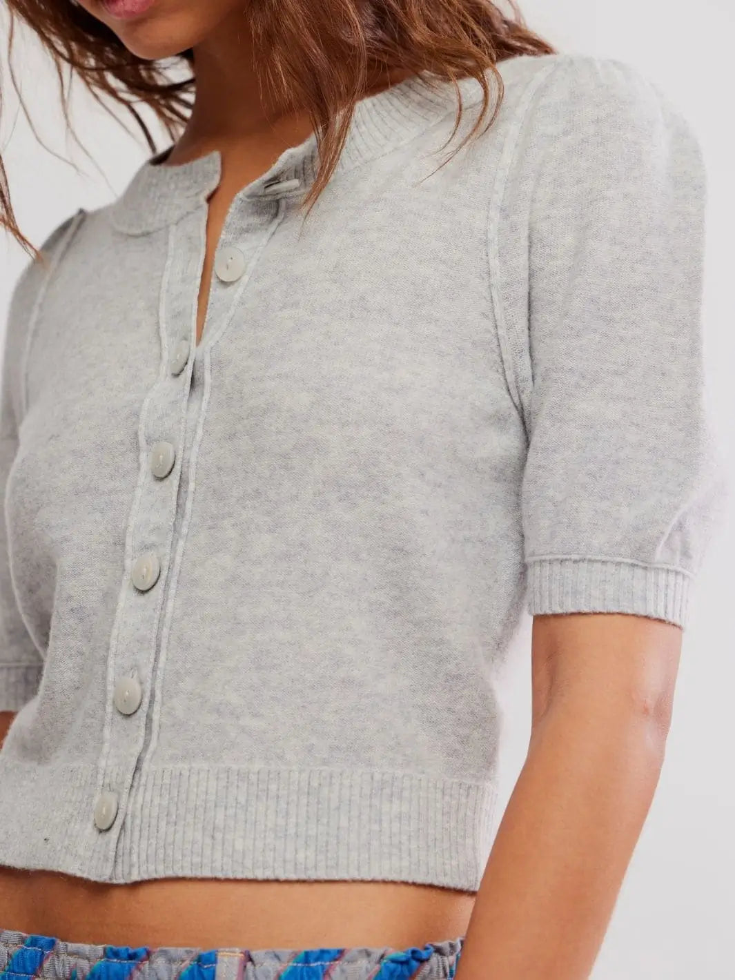 A detailed close-up shot focuses on the tonal front button closures and soft heathered texture of the Free People Isla Solid Cardi - Mineral Grey | Twentyseven Toronto
