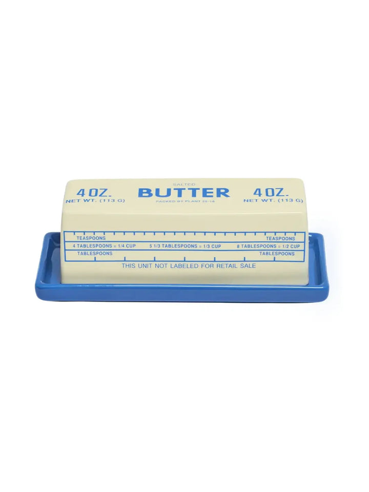 A front view of the Item - Butter Stick Butter Dish from Fishs Eddy, showing the bold blue "SALTED BUTTER 4 OZ." text printed across the top of the ceramic lid | Twentyseven Toronto