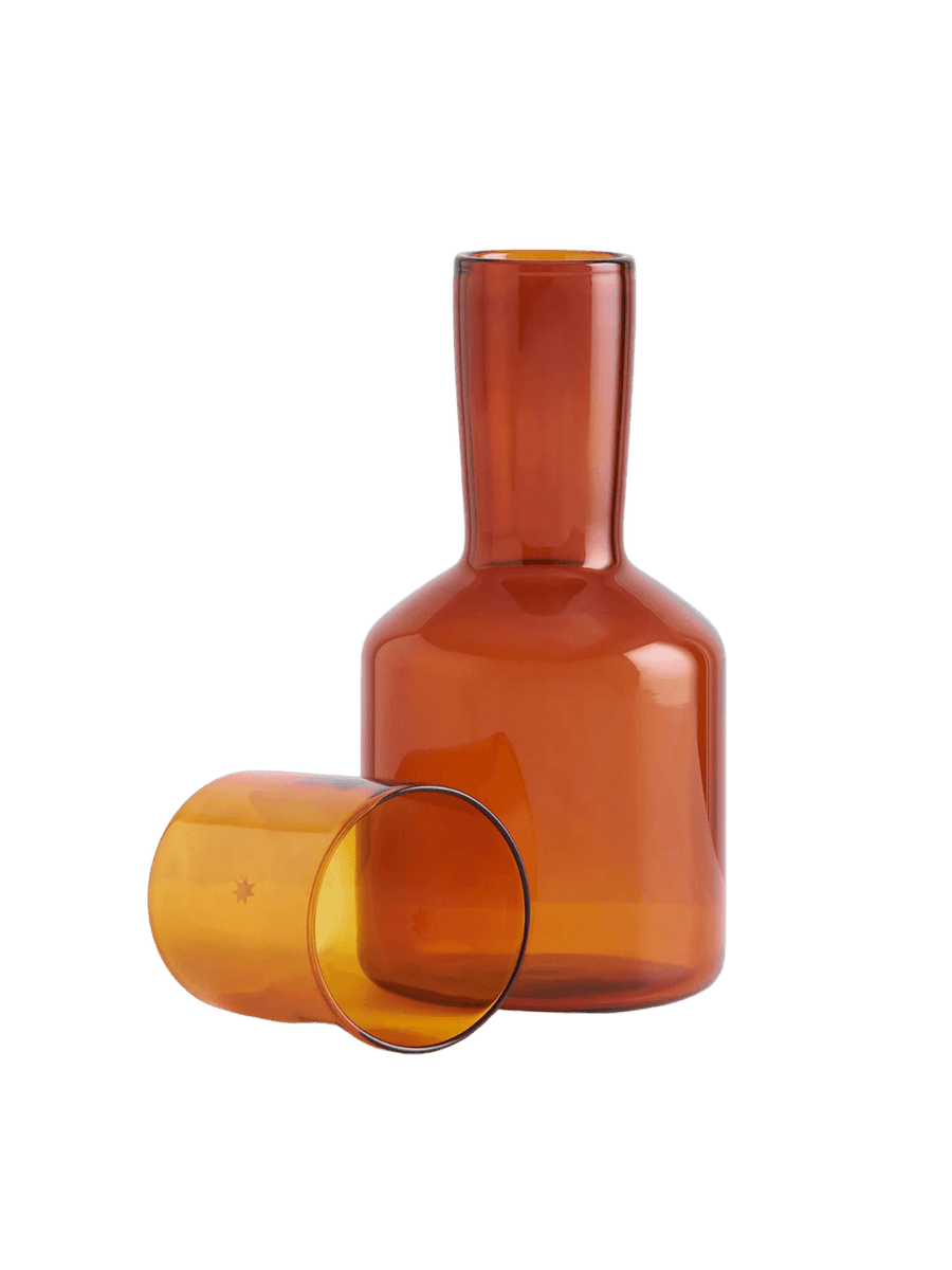 Amber glass 'J'ai Soif' carafe and glass from Maison Balzac on a transparent background | Twentyseven Toronto