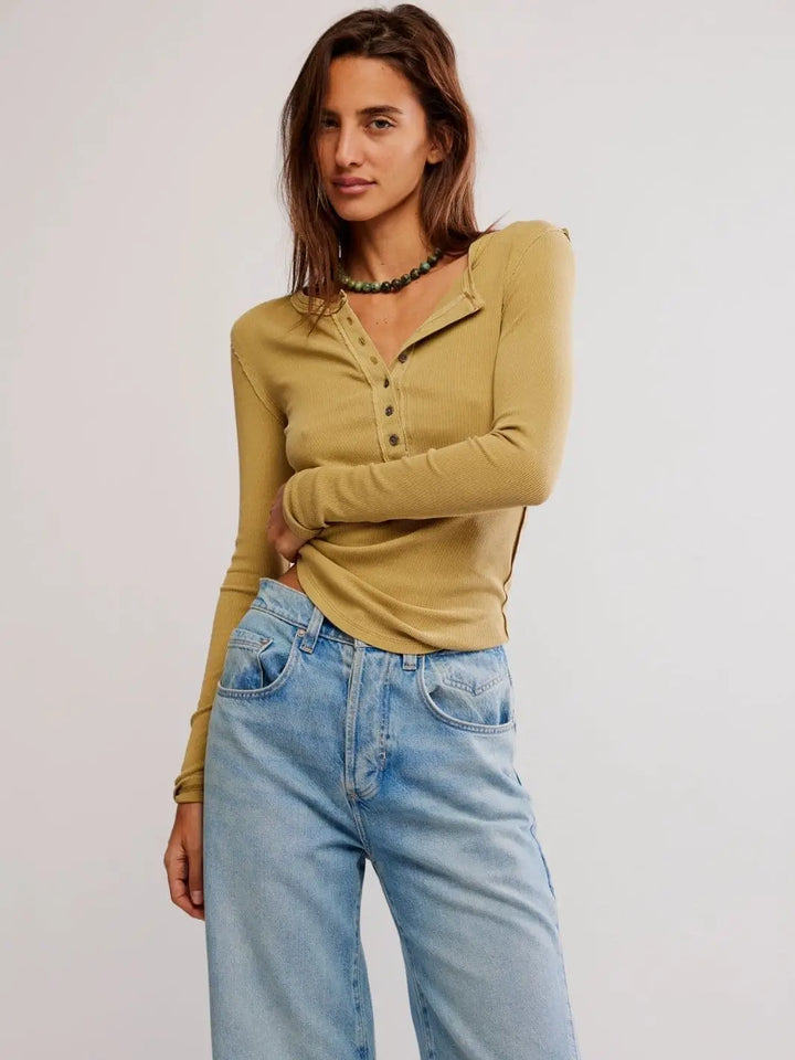 A model poses from the front wearing the fitted, long-sleeve Free People Jamie Henley - Tobacco paired with light wash blue jeans | Twentyseven Toronto