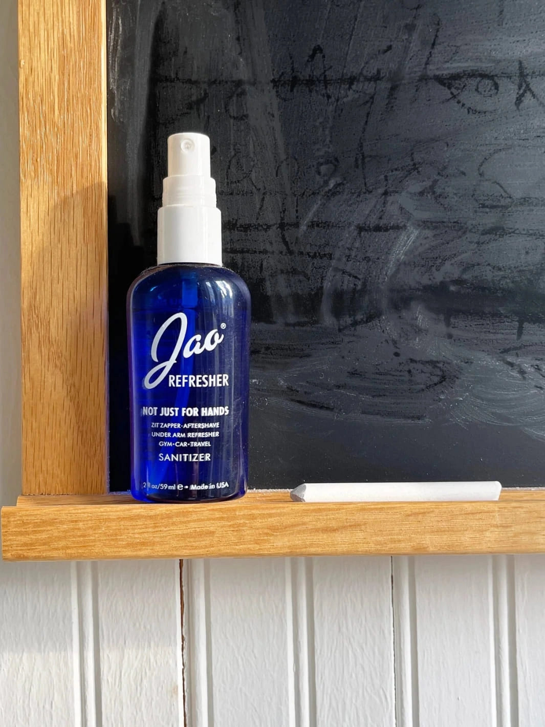 Blue bottle of Jao Refresher on a wooden shelf with a chalkboard background 2 fl oz | Twentyseven Toronto