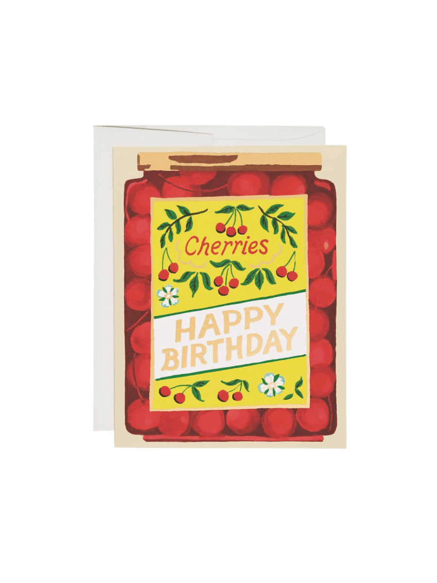 A Jar of Cherries Birthday Greeting Card features a colorful illustration of a mason jar filled with red cherries and a yellow label reading "HAPPY BIRTHDAY," shown next to a white envelope | Twentyseven Toronto