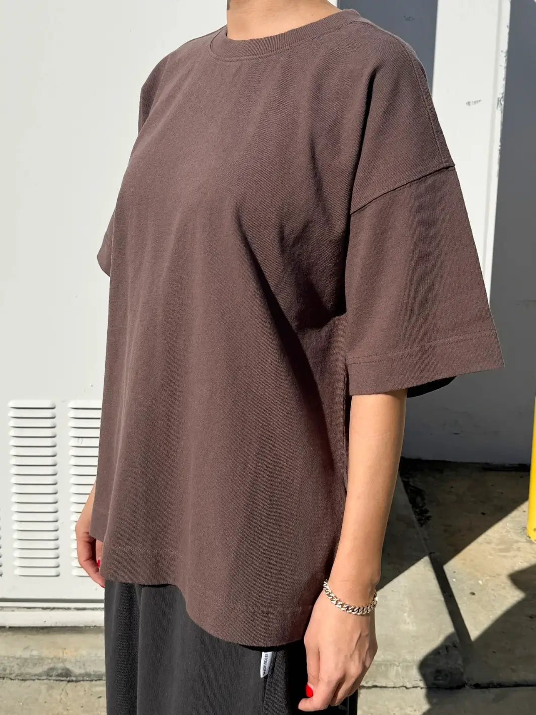 Person wearing dark brown 'Jayden Tee' t-shirt in 'Chocolate 'from Le Bon Shoppe against a white background, 45 degree view | Twentyseven Toronto