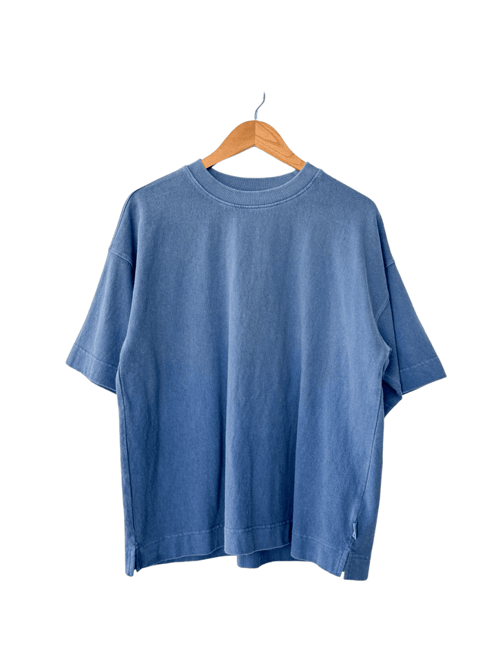 Blue 'Jayden Tee' t-shirt in 'Cornflower' from Le Bon Shoppe on a wooden hanger | Twentyseven Toronto