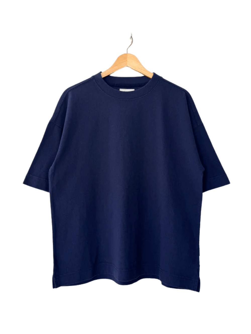A dark navy, crewneck Le Bon Shoppe Jayden Tee - Midnight with wide sleeves hangs neatly on a wooden hanger | Twentyseven Toronto