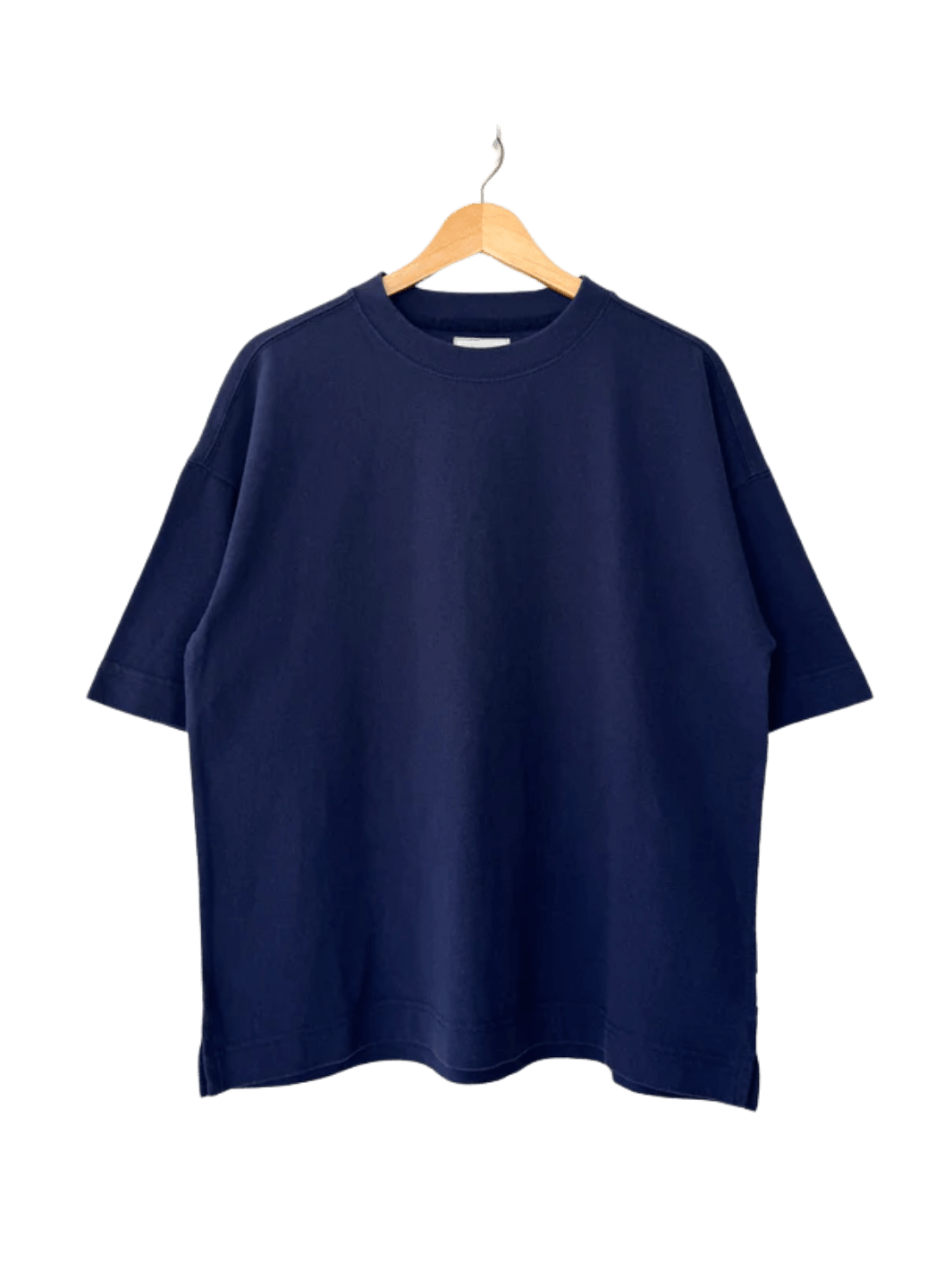 A dark navy, crewneck Le Bon Shoppe Jayden Tee - Midnight with wide sleeves hangs neatly on a wooden hanger | Twentyseven Toronto