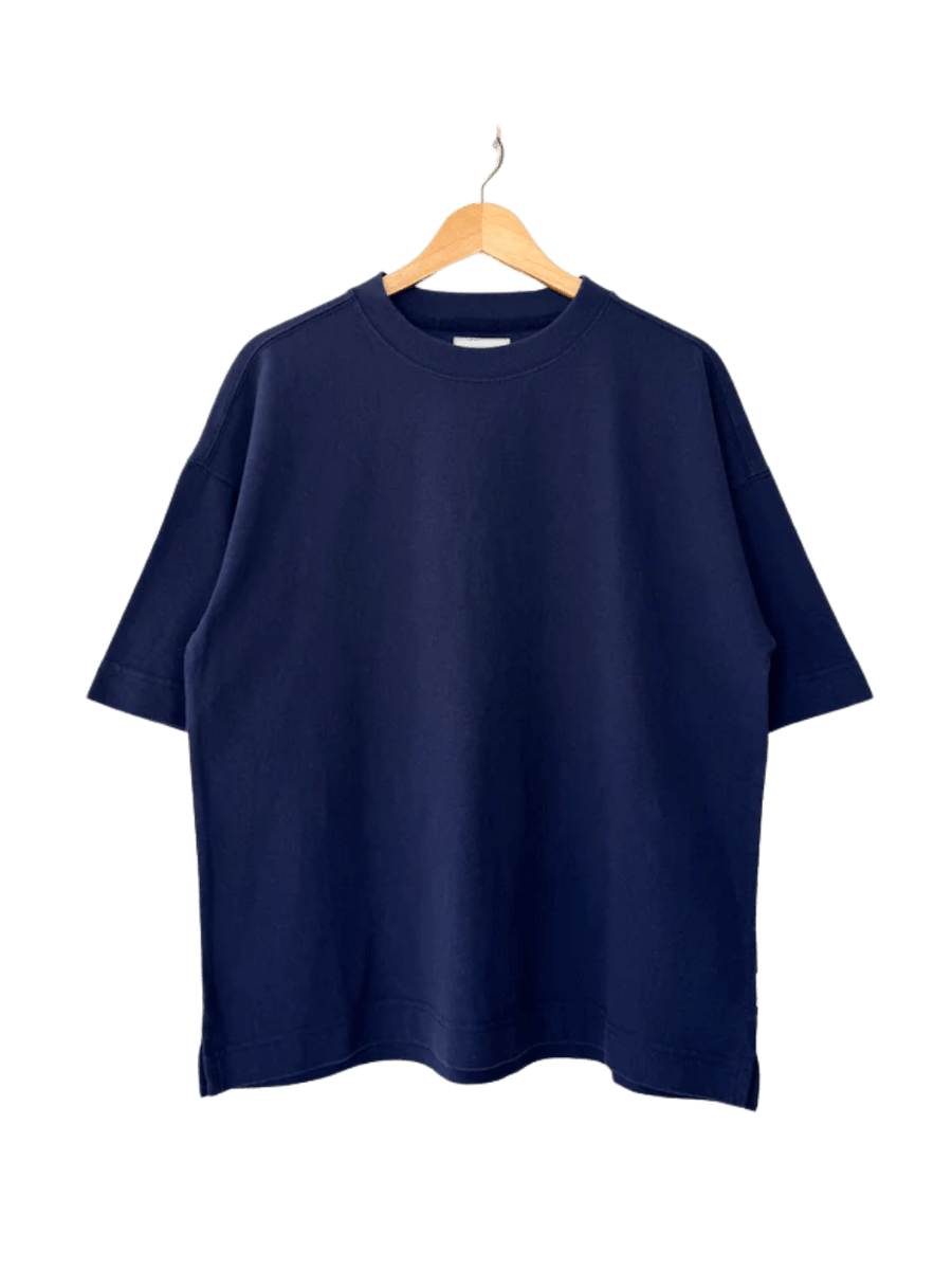 A dark navy, crewneck Le Bon Shoppe Jayden Tee - Midnight with wide sleeves hangs neatly on a wooden hanger | Twentyseven Toronto