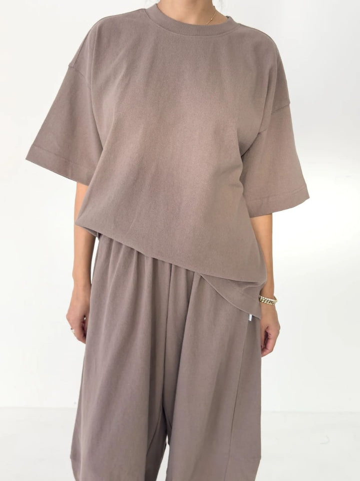 Person wearing brown 'Jayden Tee' t-shirt in 'Mushroom' from Le Bon Shoppe with matching brown pants on a white background | Twentyseven Toronto