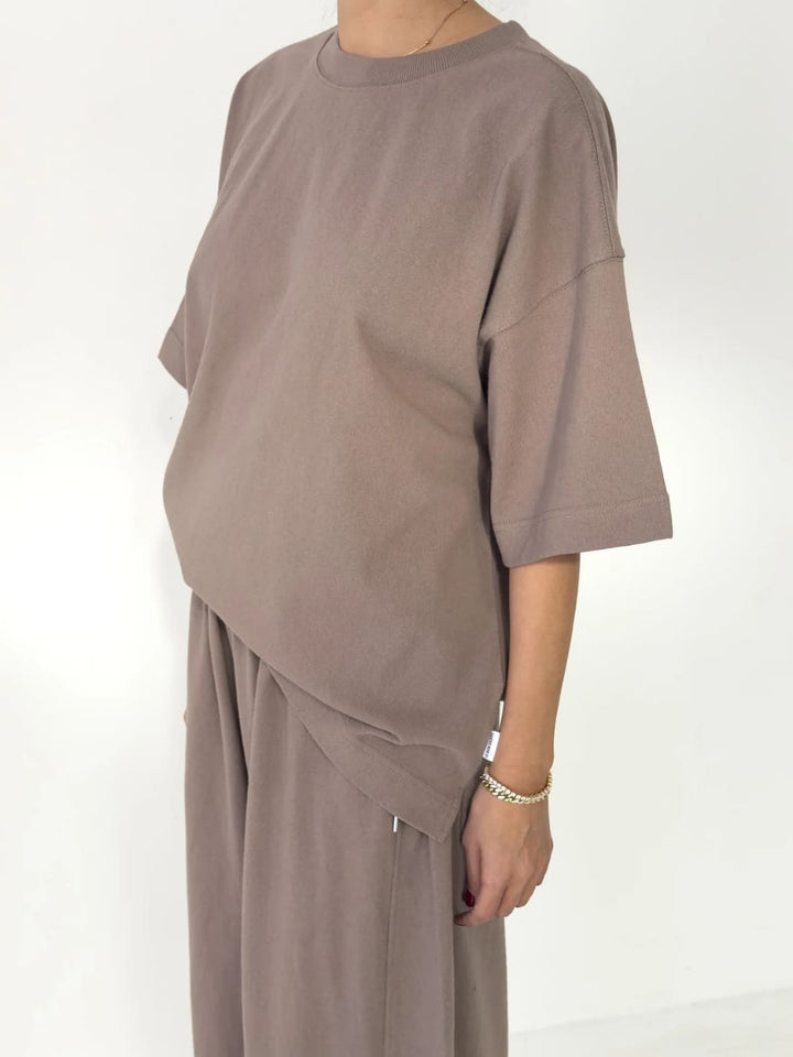 Person wearing brown 'Jayden Tee' t-shirt in 'Mushroom 'from Le Bon Shoppe with matching brown pants on a white background, 45 degree view | Twentyseven Toronto