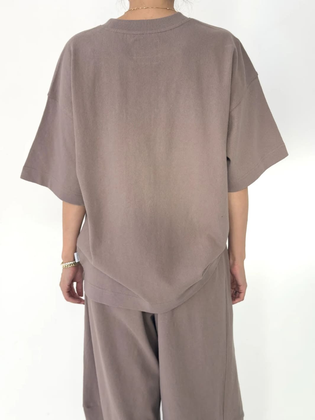 Person wearing brown 'Jayden Tee' t-shirt in 'Mushroom' from Le Bon Shoppe with matching brown pants on a white background, back view | Twentyseven Toronto