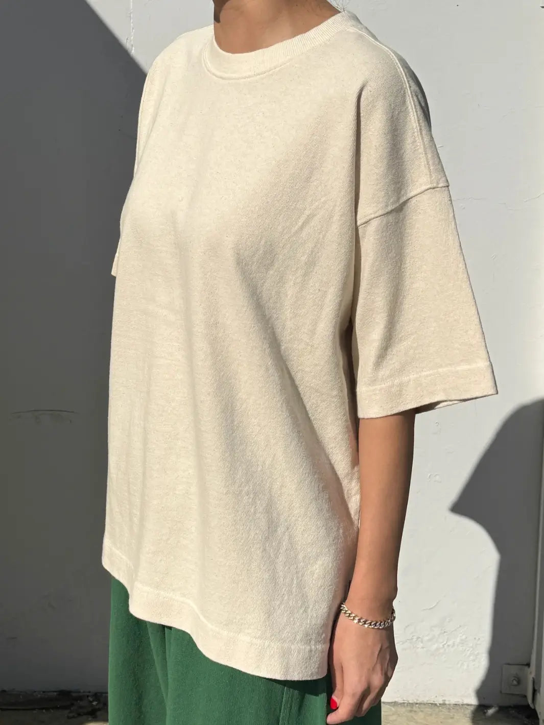 Person wearing cream 'Jayden Tee' t-shirt in 'Naturel' from Le Bon Shoppe on a white background | Twentyseven Toronto