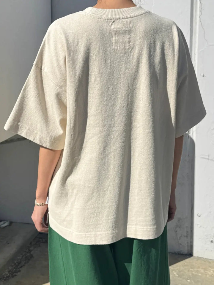 Back view of person wearing cream 'Jayden Tee' t-shirt in 'Naturel' from Le Bon Shoppe on a white background | Twentyseven Toronto