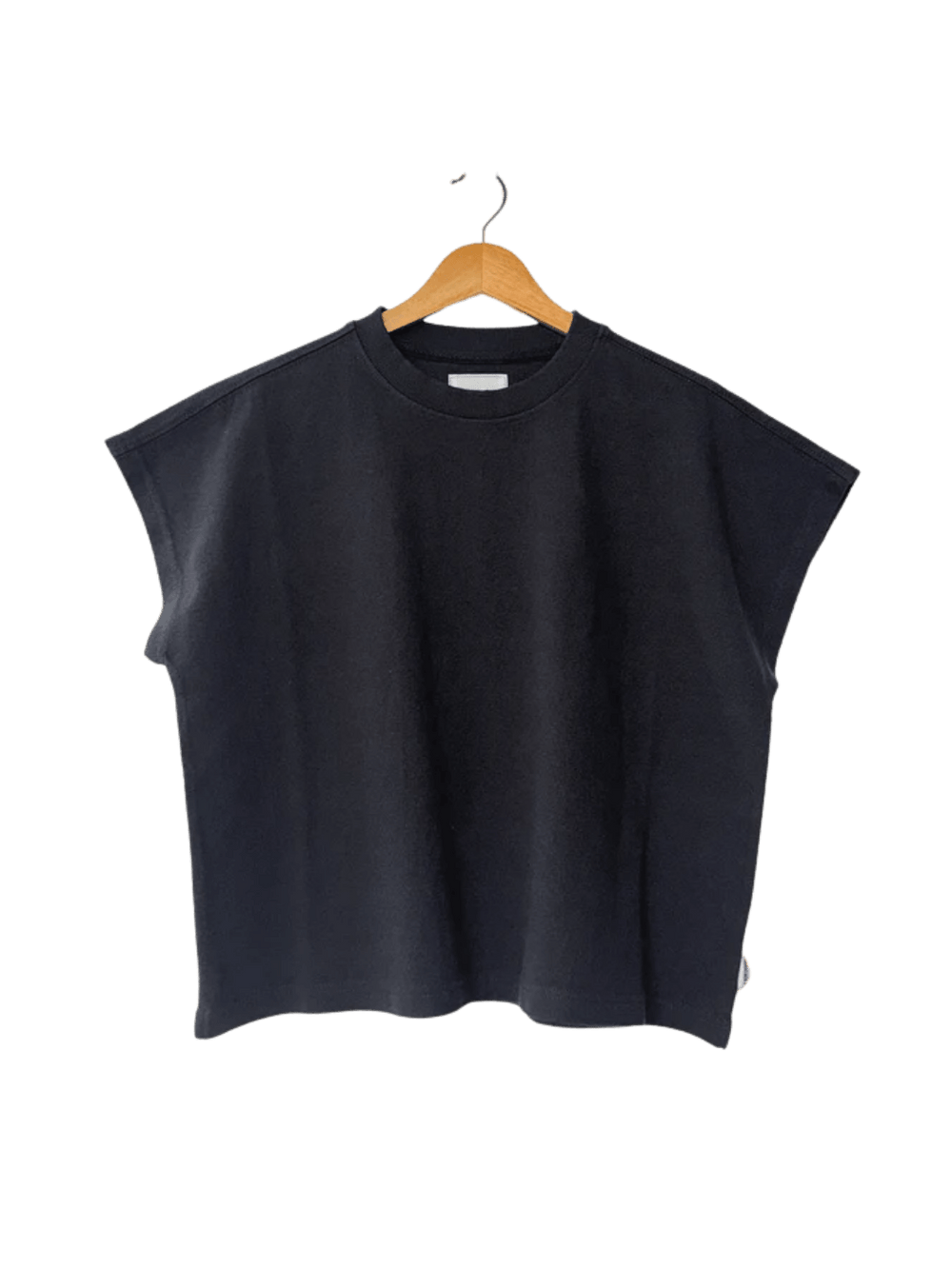 A boxy, dark charcoal grey crewneck Le Bon Shoppe Jeanne Tee in Dark Slate with extended cap sleeves hangs from a light wooden hanger | Twentyseven Toronto