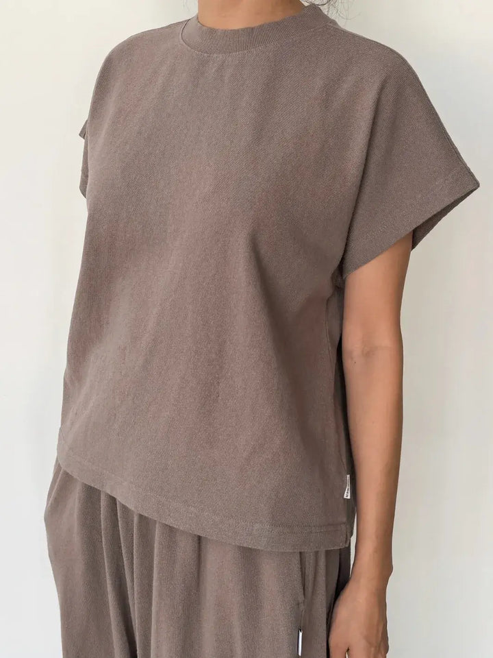 Person wearing a brown sleeveless top, 'Jeanne Tee' in 'Mushroom' from Le Bon Shoppe and matching pants on a white background | Twentyseven Toronto