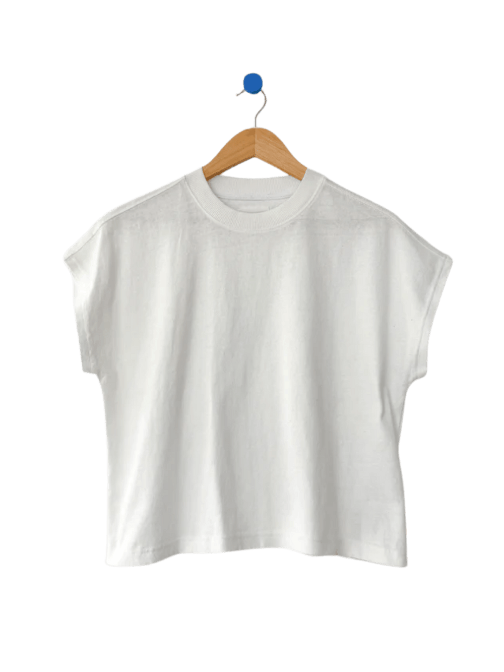The Le Bon Shoppe Jeanne Tee in White Cotton hangs neatly from a wooden clothing hanger | Twentyseven Toronto