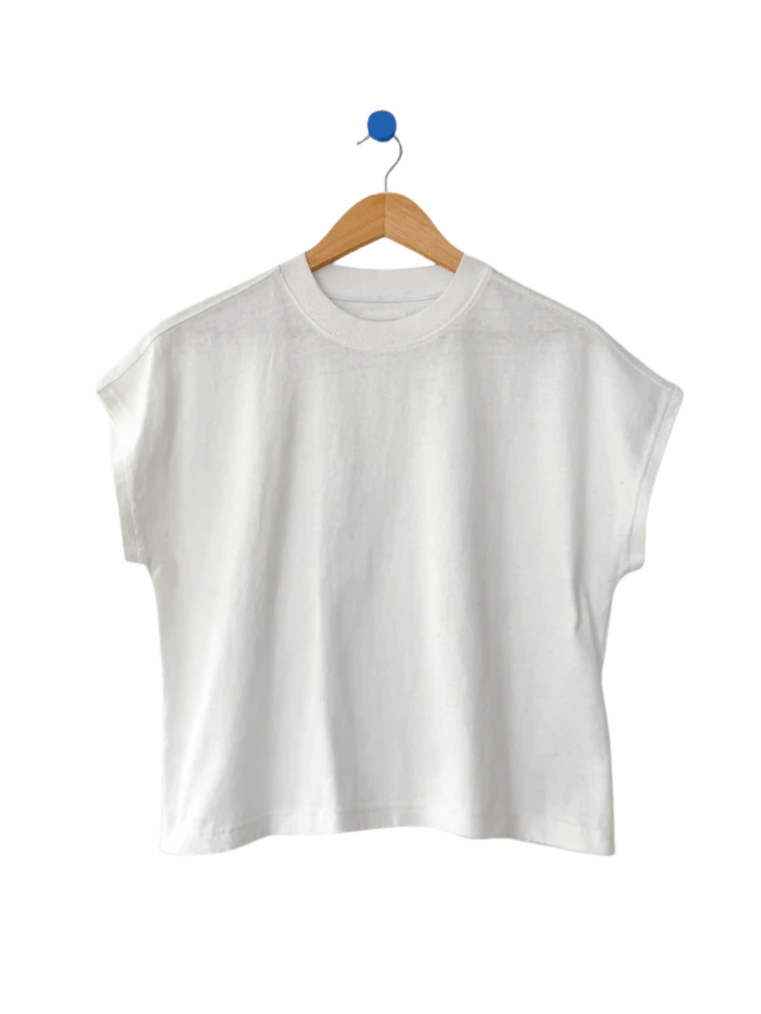 The Le Bon Shoppe Jeanne Tee in White Cotton hangs neatly from a wooden clothing hanger | Twentyseven Toronto