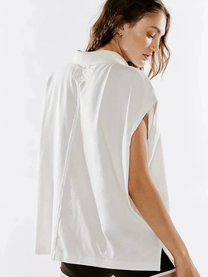 A back angle captures the exposed seam detail and relaxed, sleeveless silhouette of the Free People Keep On Polo - Clean Ivory | Twentyseven Toronto