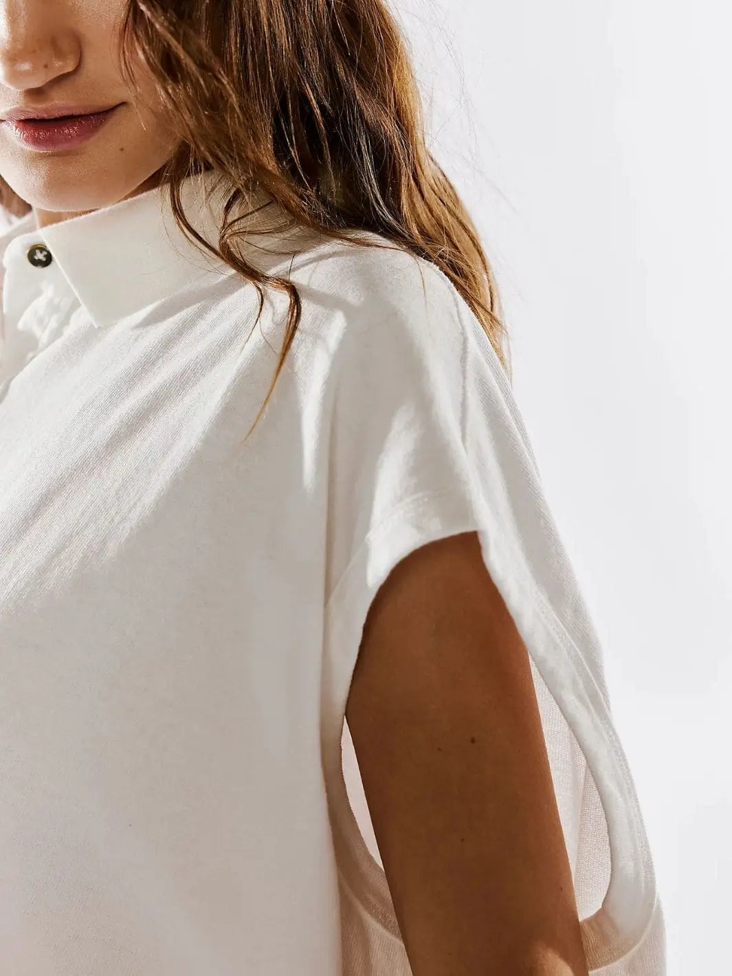 A close-up side view highlights the cap-style sleeveless armhole structure and collar of the Free People Keep On Polo - Clean Ivory | Twentyseven Toronto