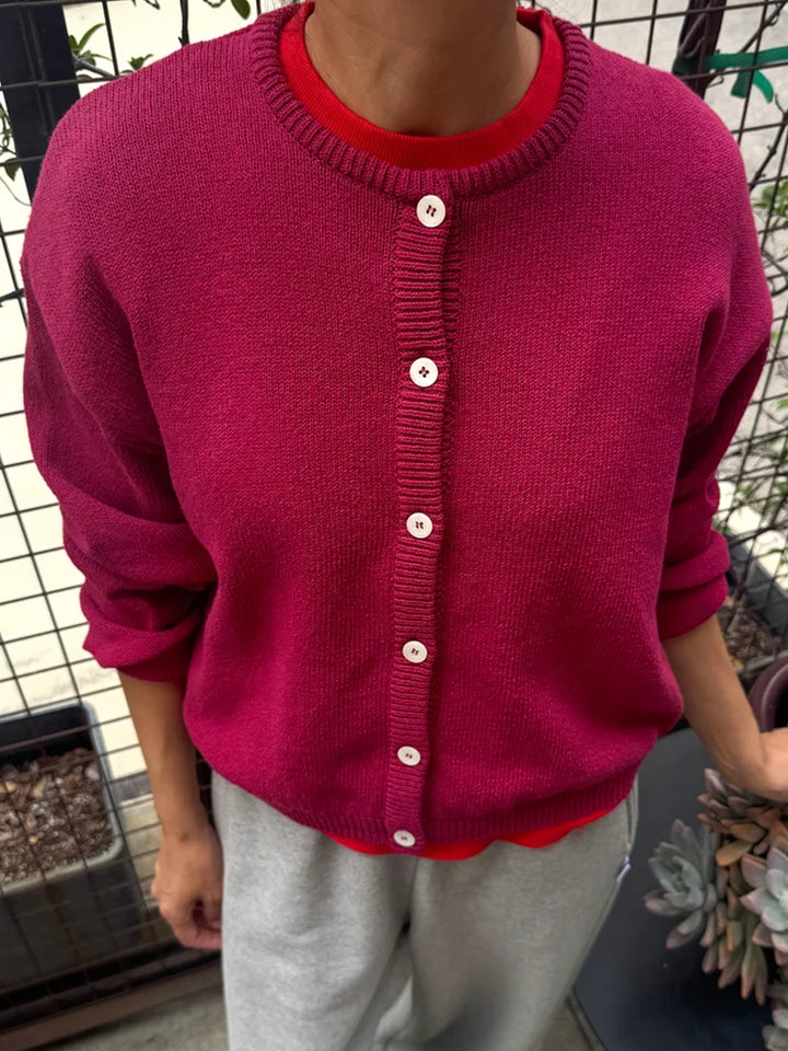Model wearing the Le Bon Shoppe Laila Cardigan in Prune over a red top | Twentyseven Toronto