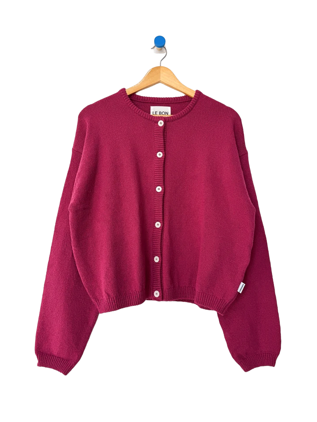 Le Bon Shoppe Laila Cardigan in Prune on a wooden hanger | Twentyseven Toronto