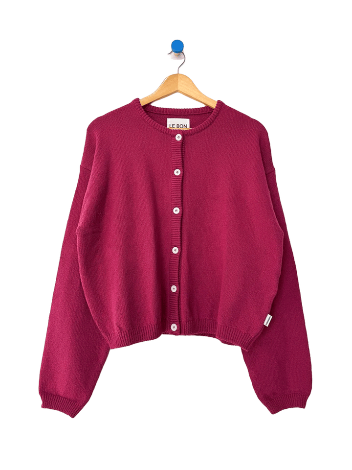 Le Bon Shoppe Laila Cardigan in Prune on a wooden hanger | Twentyseven Toronto