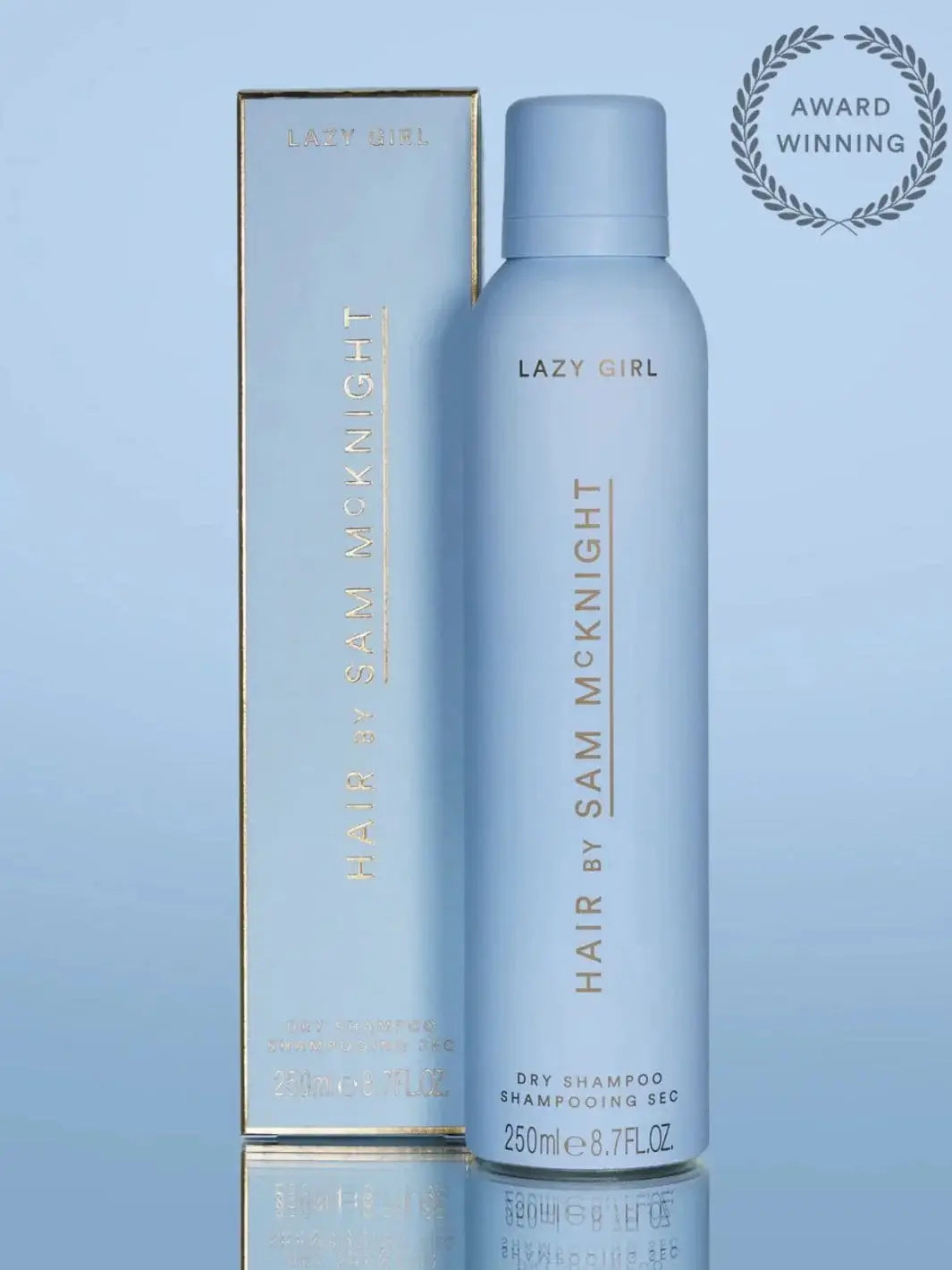A light blue aerosol can and its matching box stand together to showcase the award-winning packaging of Hair by Sam McKnight Lazy Girl Dry Shampoo | Twentyseven Toronto