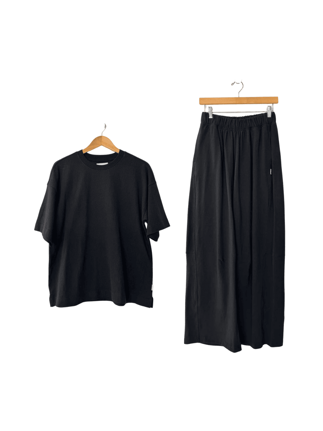 Le Bon Shoppe Jayden Tee in 'black' t-shirt and Bare Pants in 'black' wide-leg pants on hangers | Twentyseven Toronto