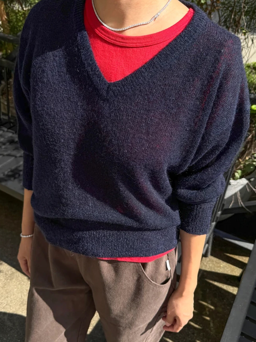 Le Bon Shoppe Matthew V-Neck Mohair Sweater in navy layered over a red crewneck top with brown trousers | Twentyseven Toronto