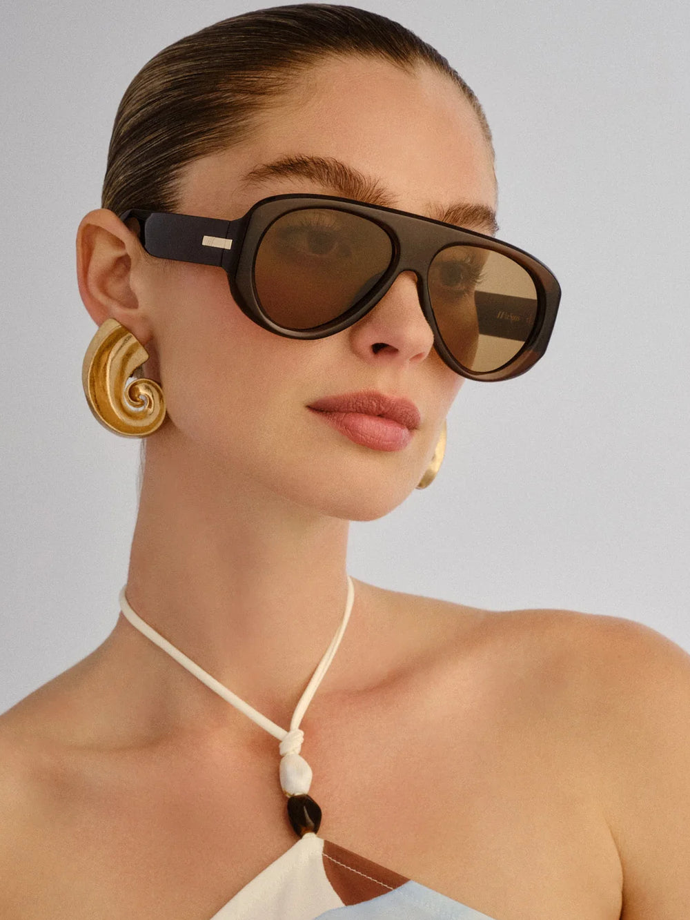 Model wearing Le Specs Dream Boat sunglasses in Cocoa with light brown lenses | Twentyseven Toronto