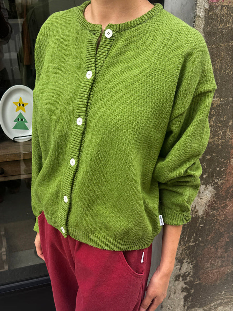 Model wearing the Leila Cotton Cardigan in Avocado with burgundy pants | Twentyseven Toronto